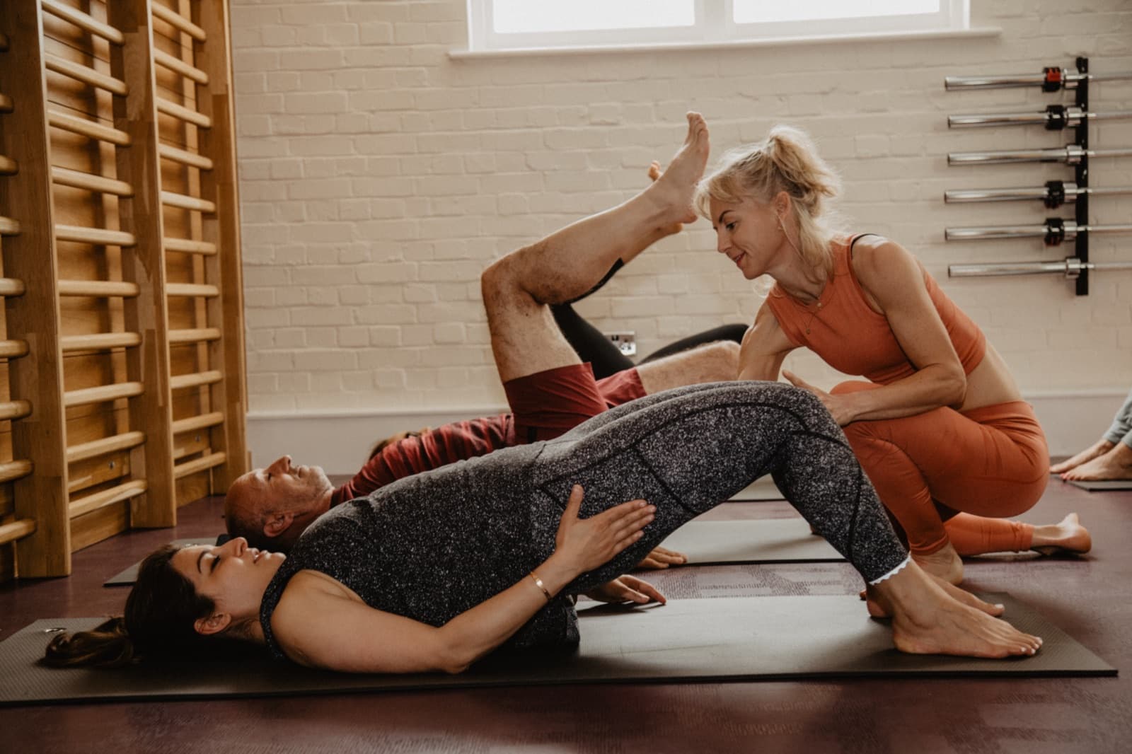 Suzanne Ferreira guiding a client through assisted stretching at SF Studios