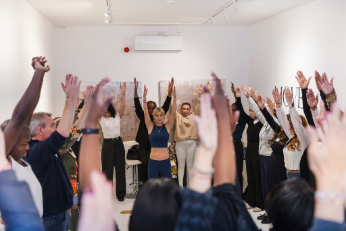 A full class raising their arms together at SF Studios